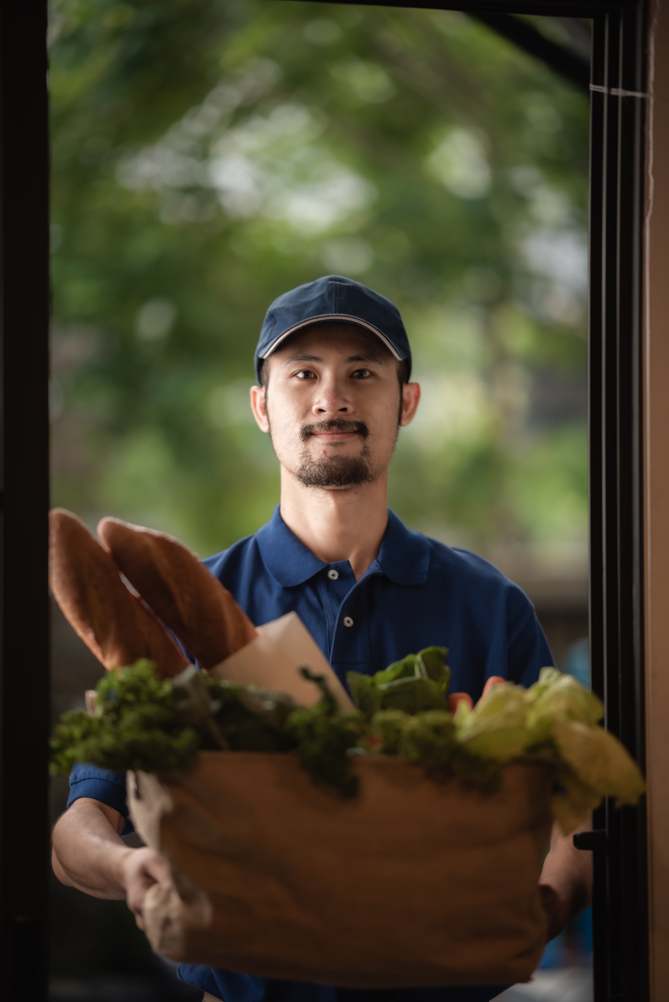 The delivery man staff are delivering fresh food to customers at home
